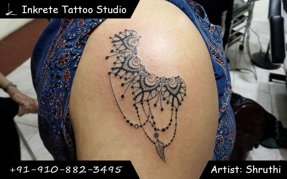 Ornamental shoulder tattoo, jewellery tattoo